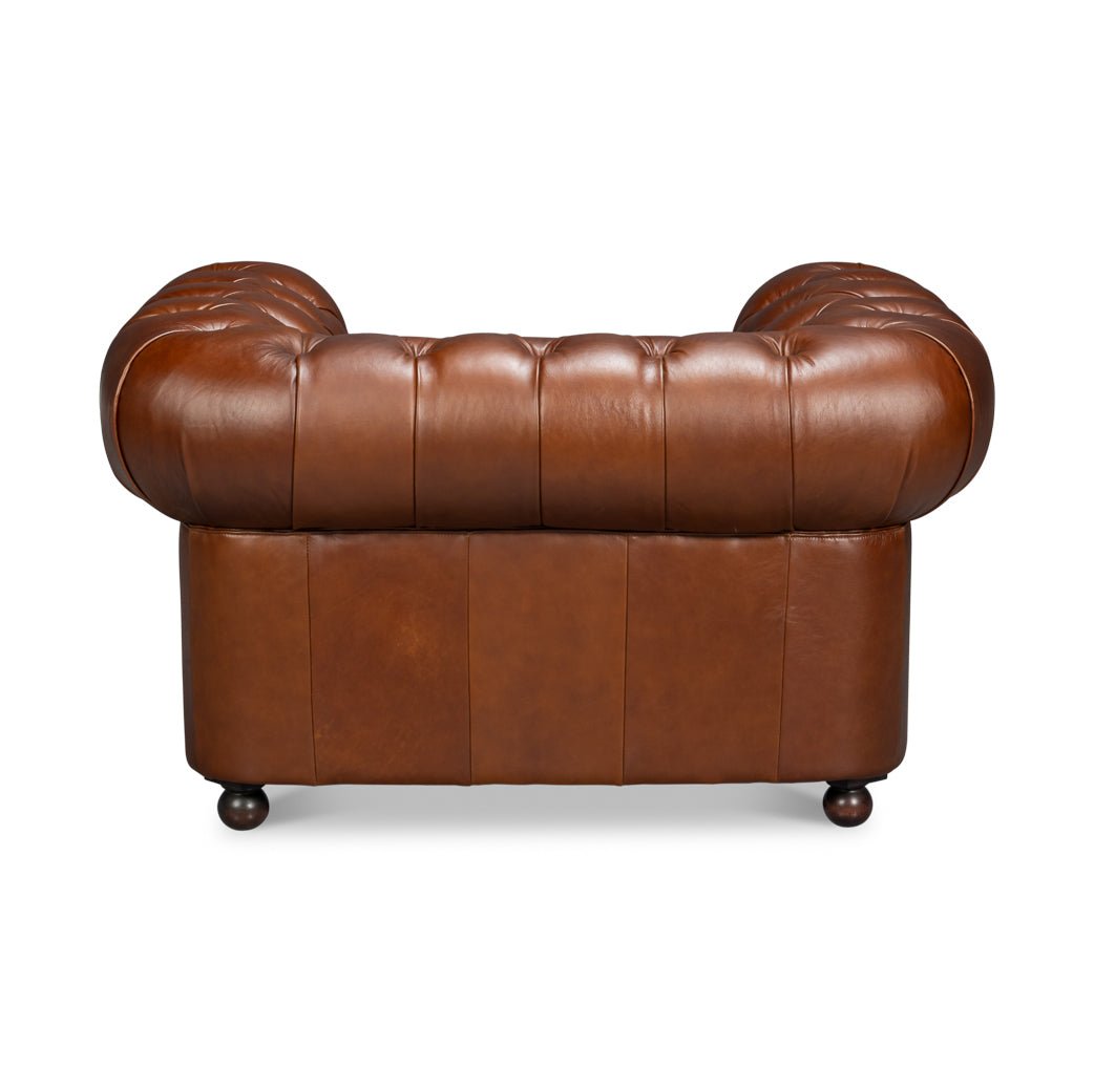 Back view, tufted brown leather Chesterfield armchair
