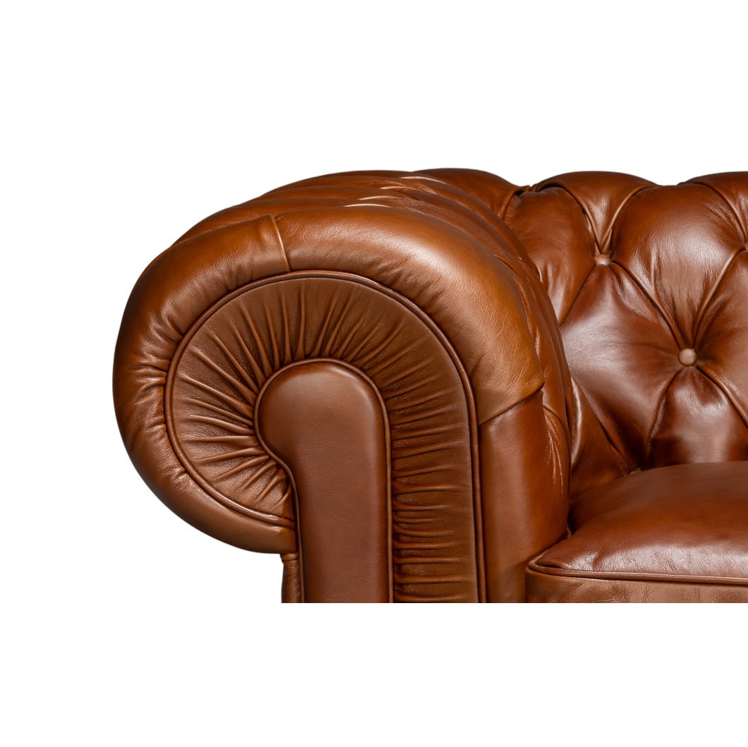 Chesterfield sofa, close-up rolled arm design, brown leather.
