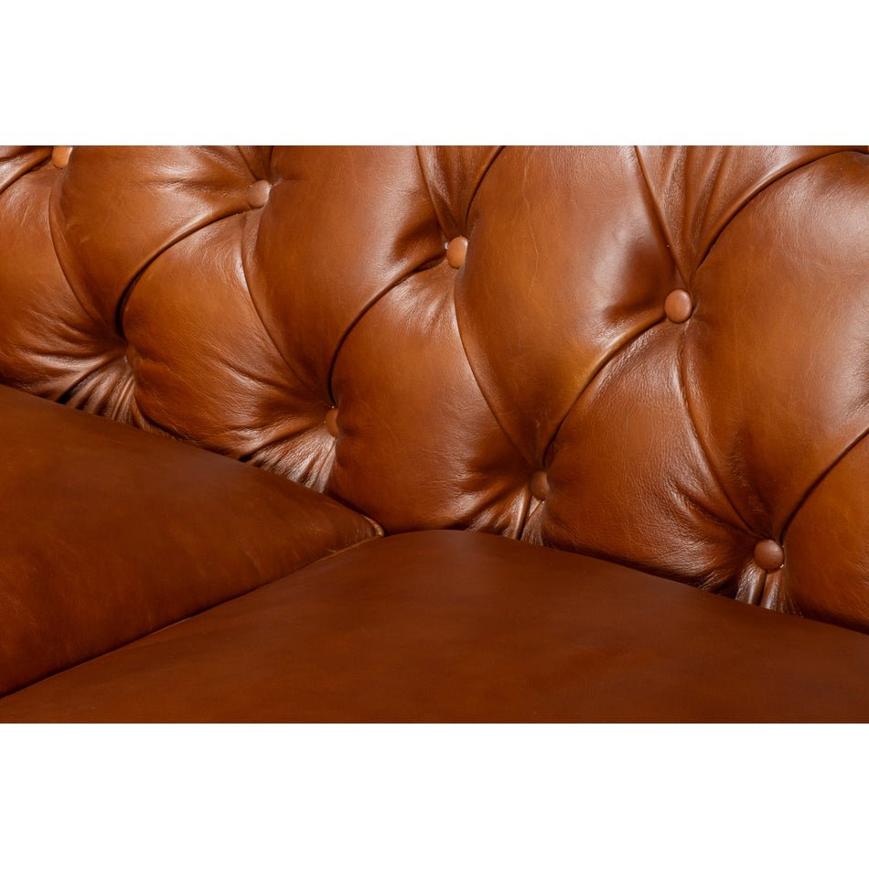 Chesterfield sofa, close-up of tufted backrest, brown leather.