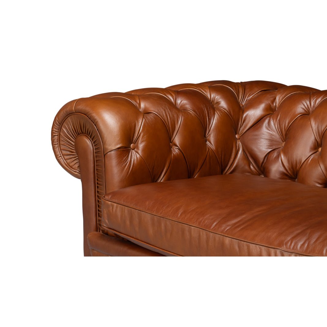 Chesterfield sofa, close-up of tufted armrest and seat.