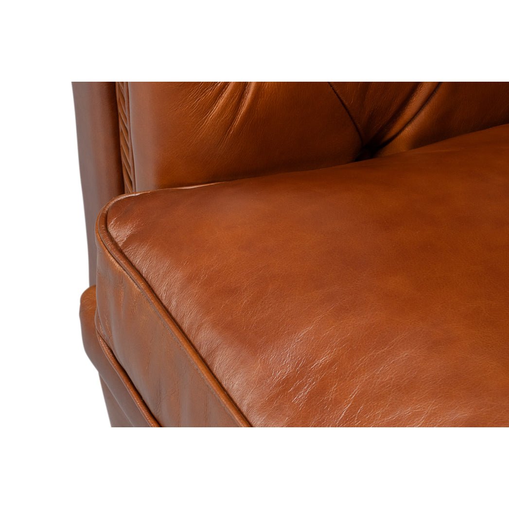 Chesterfield sofa, cushion detail, brown leather up-close.