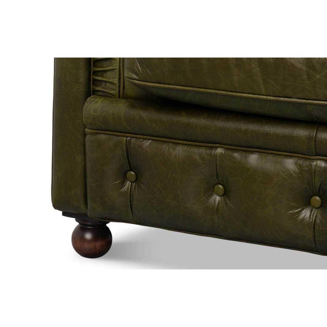 Close-up, base detail with buttoned upholstery and wooden legs.