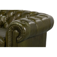 Close-up, side view of rolled arm, tufted leather.