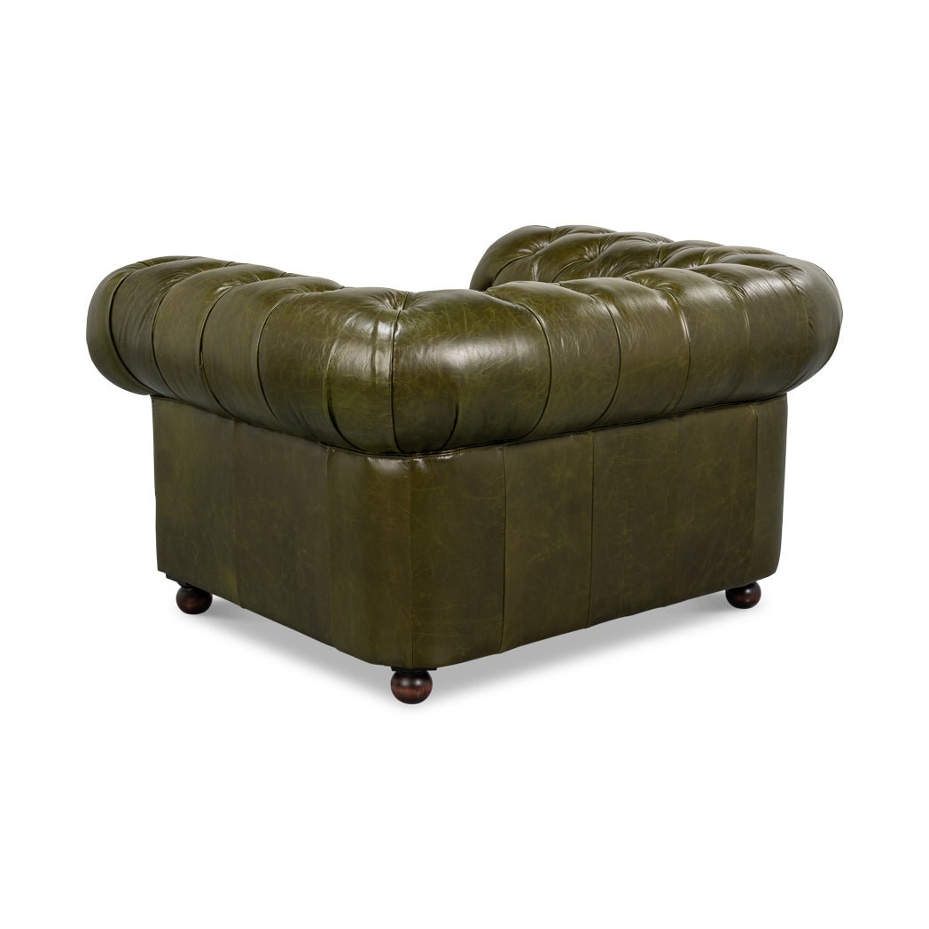 Green leather armchair, angled back view, tufted backrest.