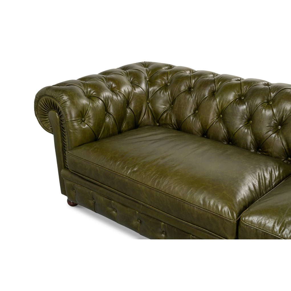 Close-up on Chesterfield sofa corner, deep button tufting.