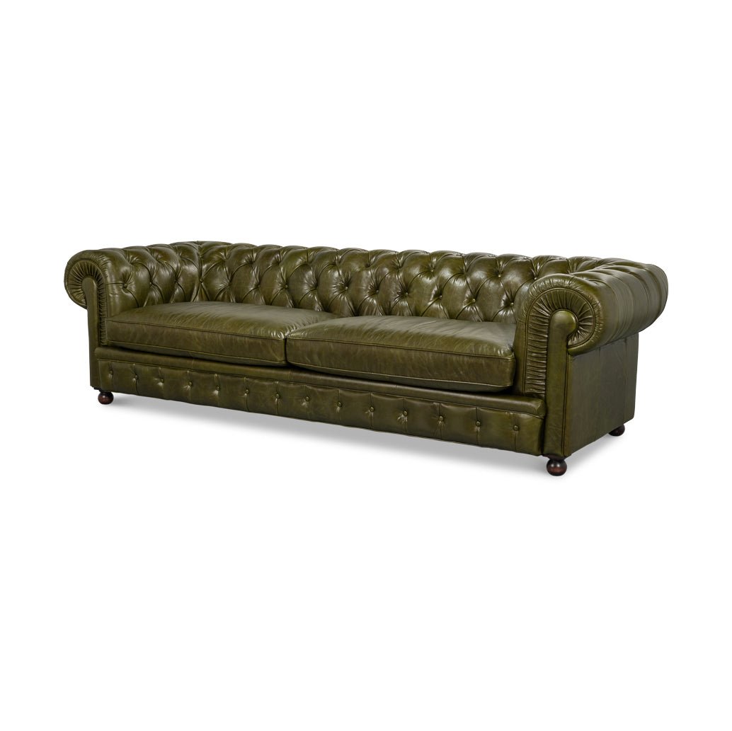 Green leather Chesterfield sofa angle view, classic design.