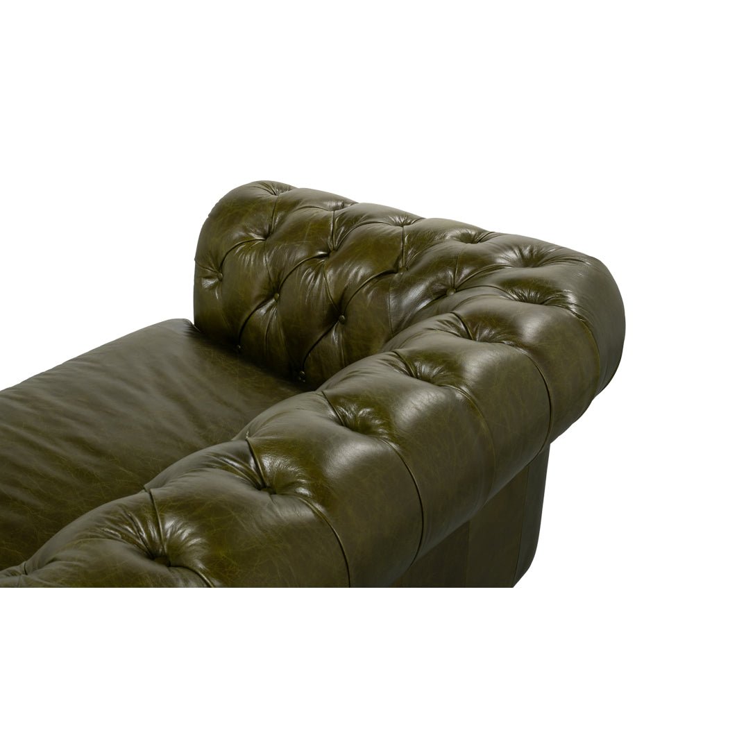 Top view of tufted armrest, green Chesterfield sofa.