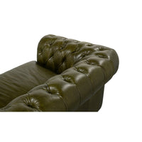 Top view of tufted armrest, green Chesterfield sofa.