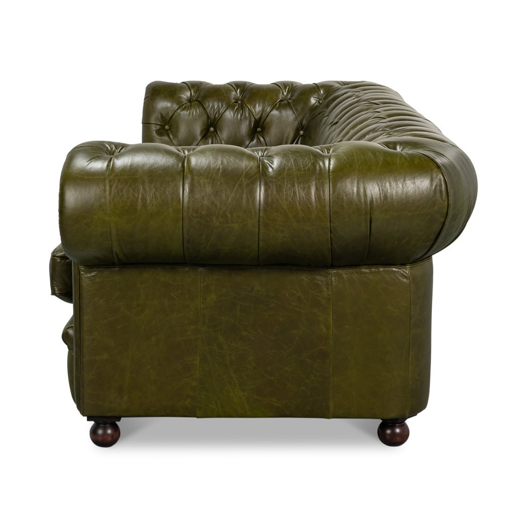 Side profile of rolled arm on leather Chesterfield sofa.