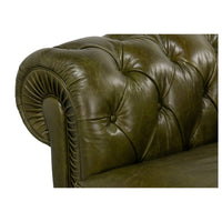 Rolled arm detail, green leather Chesterfield sofa close-up.