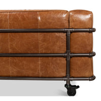 Caster wheel and piping detail on industrial leather sofa.