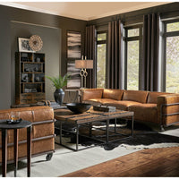 Industrial leather sofa in stylish living room setting.