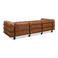 Angled back view of industrial leather sofa on casters.