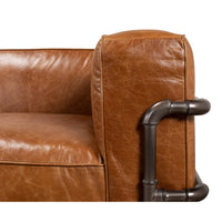 Close-up of armrest piping on industrial leather sofa.