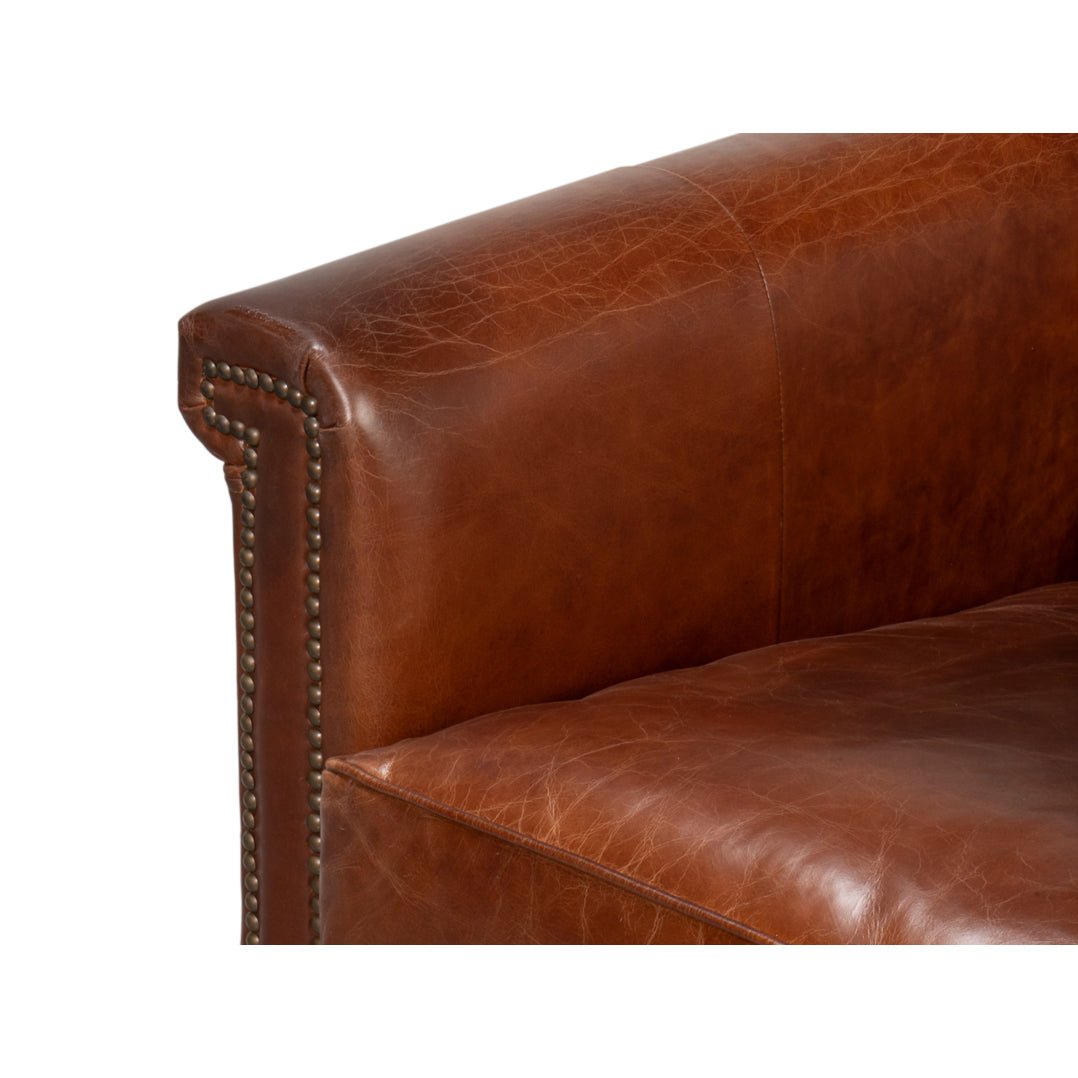 Close-up of cushion and armrest on leather accent chair.