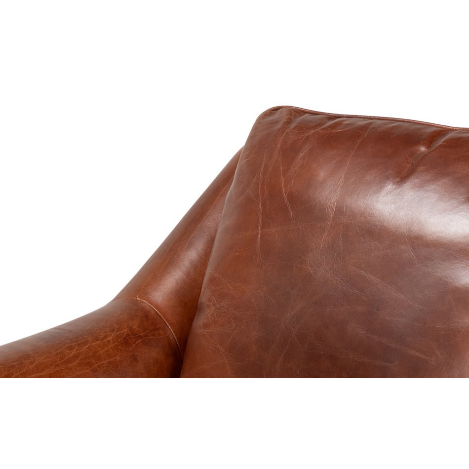 Close-up of the cushion on brown leather accent chair.