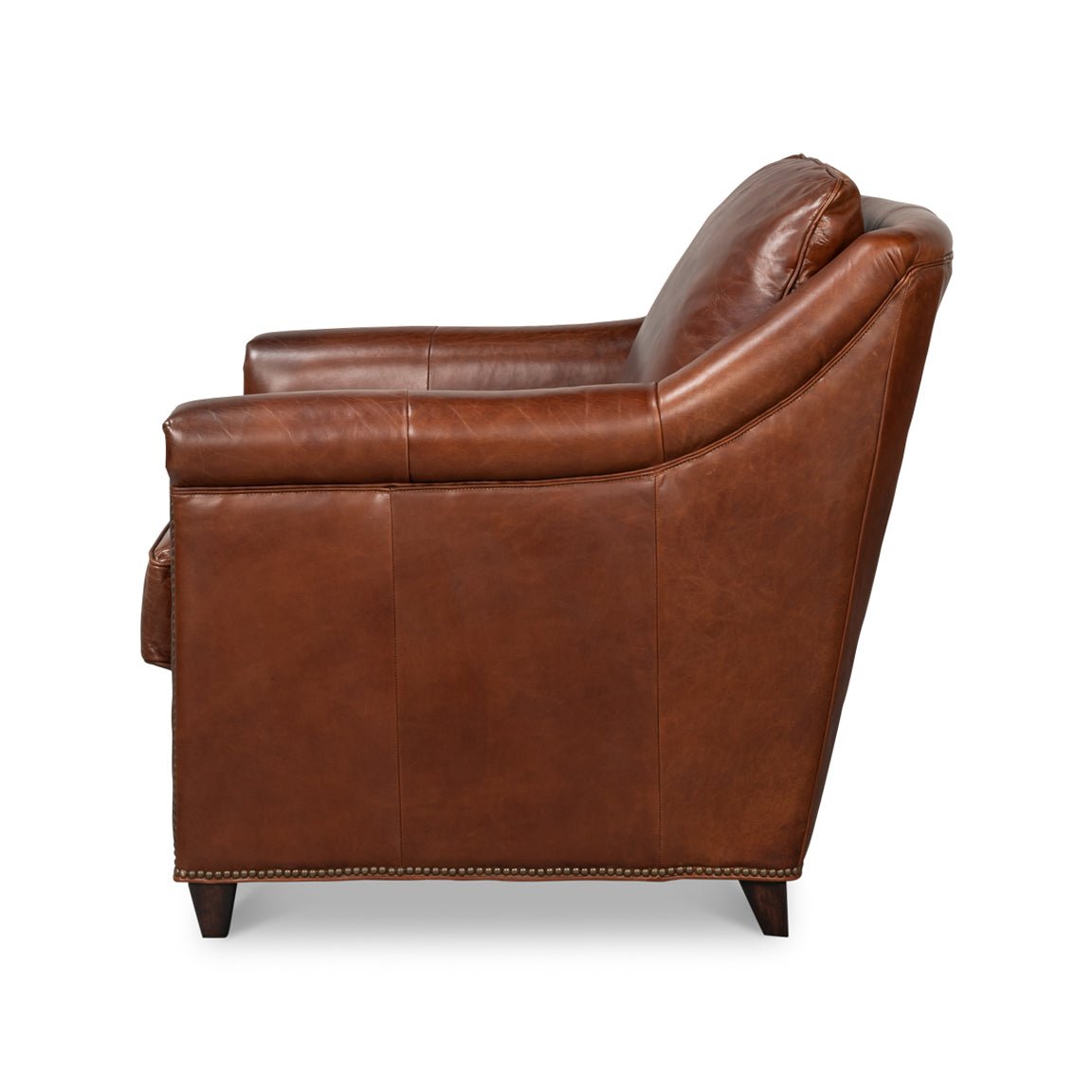 Side view of brown leather accent chair detailing armrest.