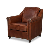 Brown leather accent chair angled view with nailhead trim.