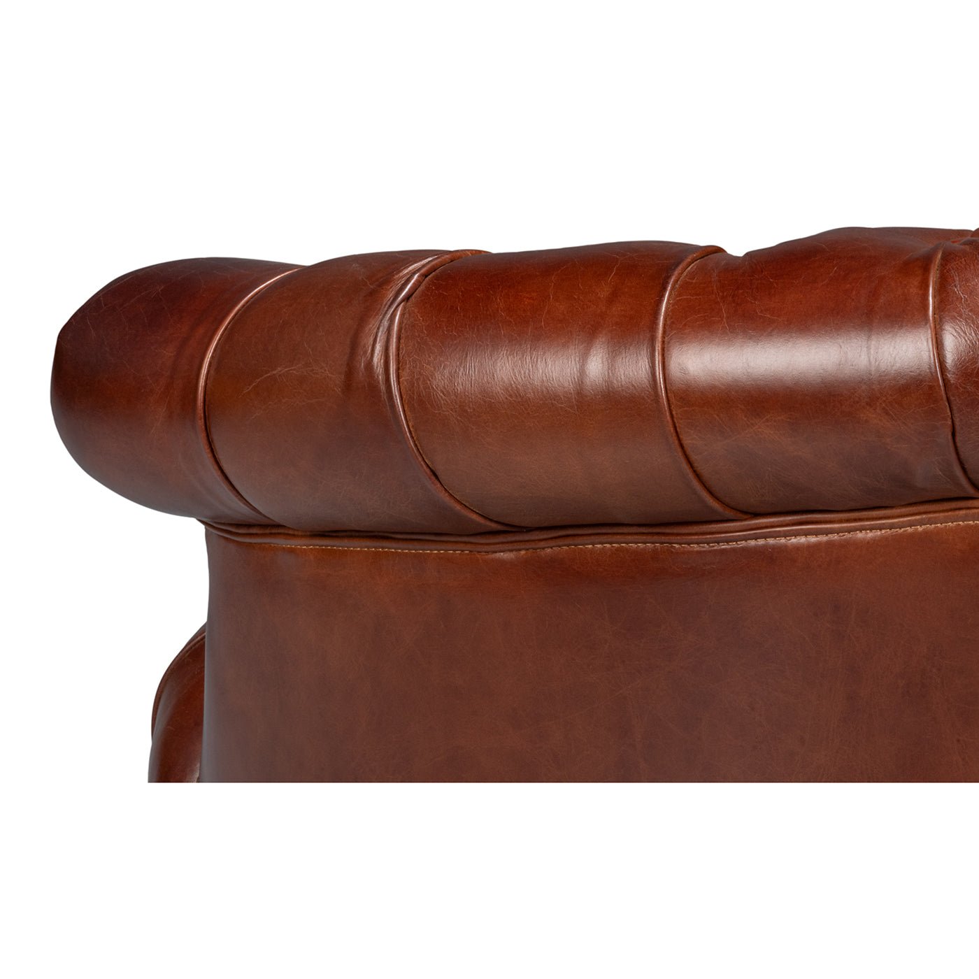 Upper back detail of brown leather barrel chair.
