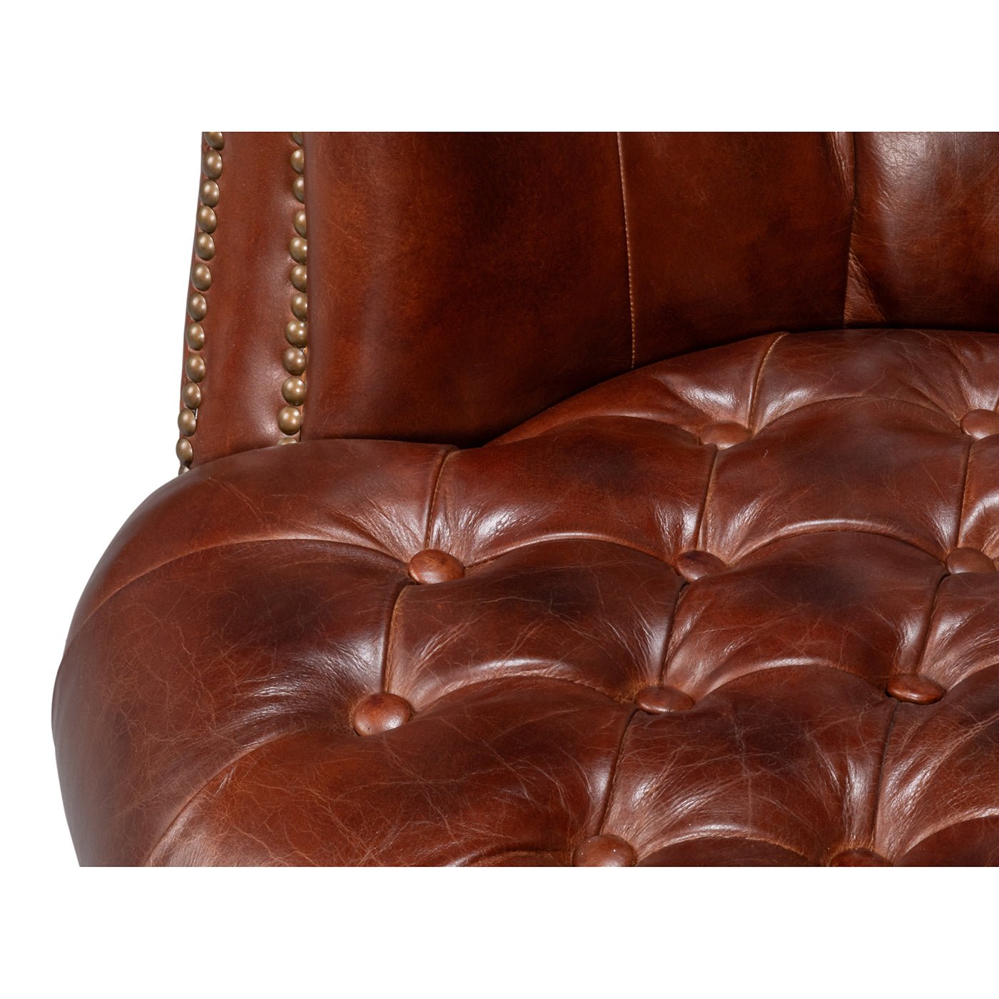 Seat cushion close-up of brown leather barrel chair.