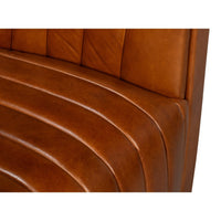 Close-up of brown leather seating detail on chair.