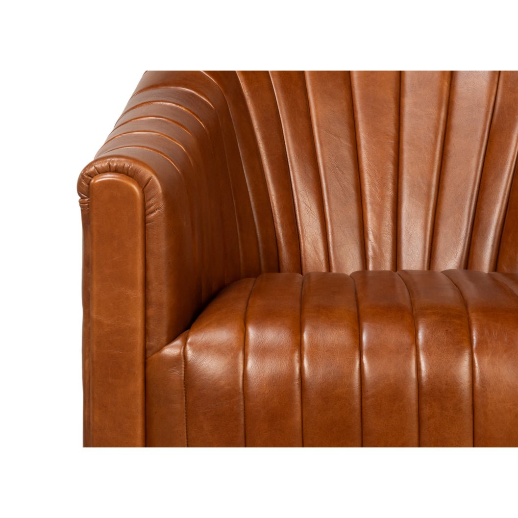 Armrest and seat details of brown leather swivel chair.