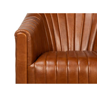 Armrest and seat details of brown leather swivel chair.