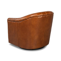 Angled side view of tufted brown leather chair.