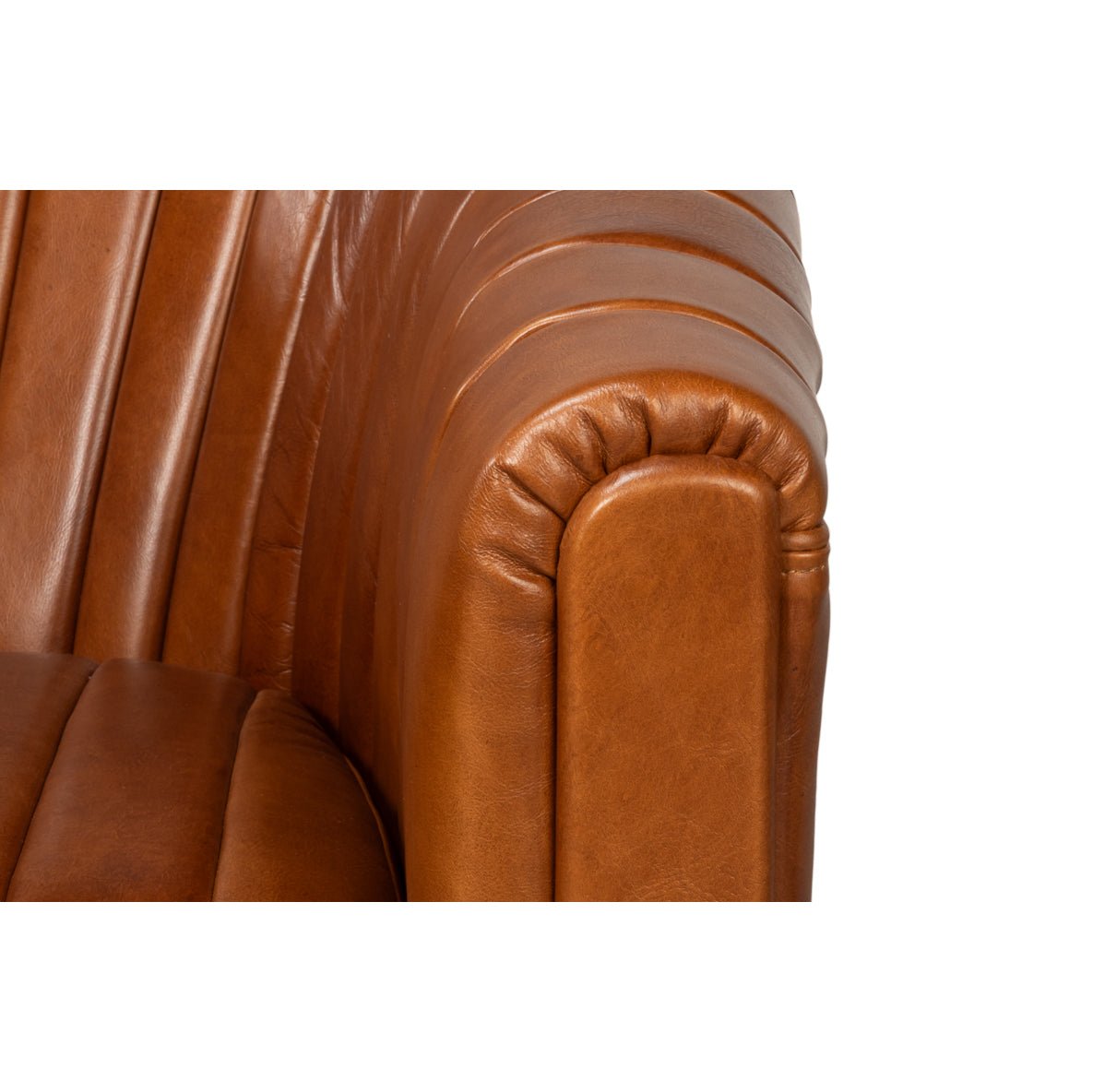 Close-up of armrest edge on tufted chair.