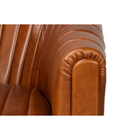 Close-up of armrest edge on tufted chair.