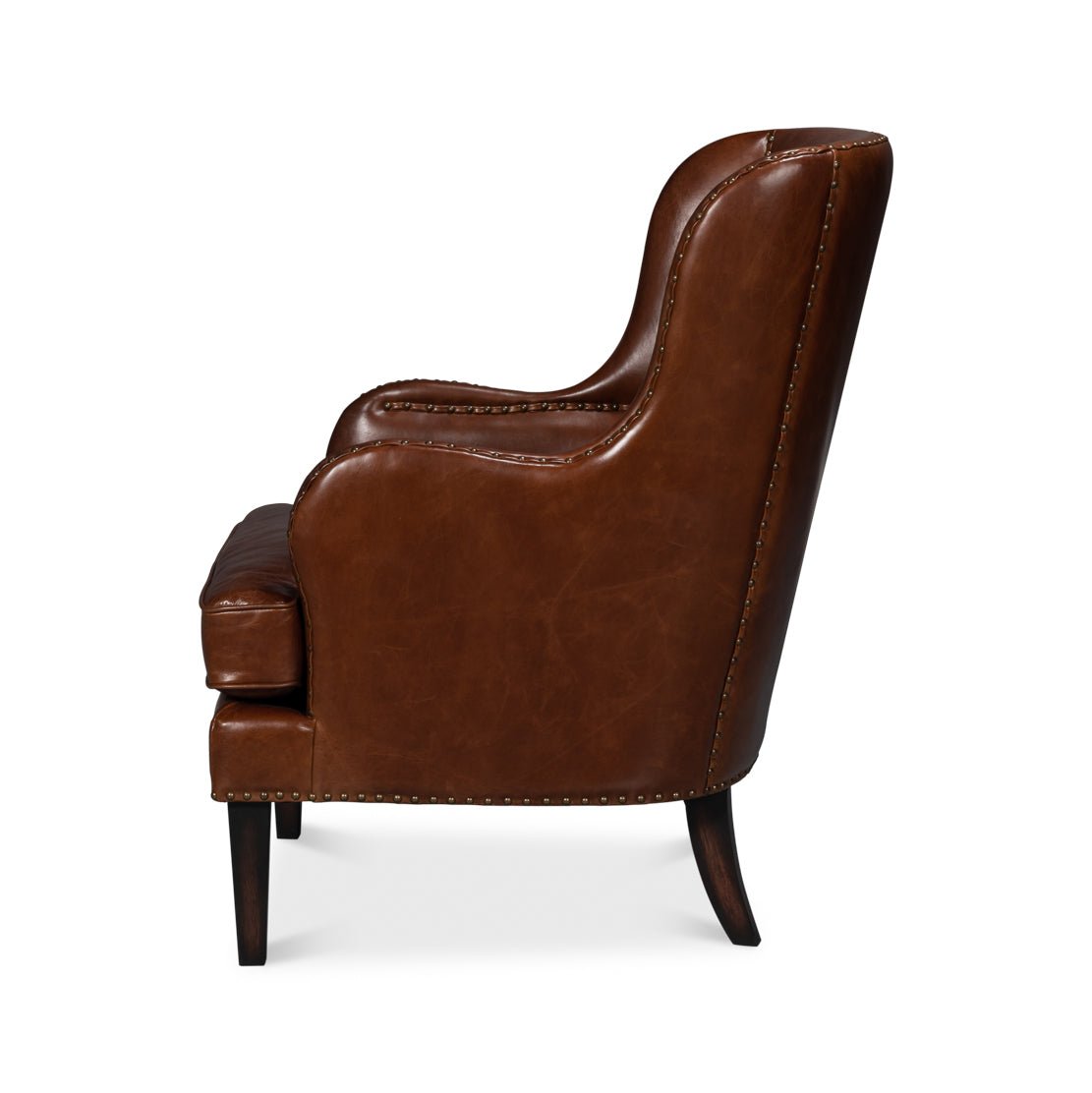 Brown leather wing chair, side profile view.