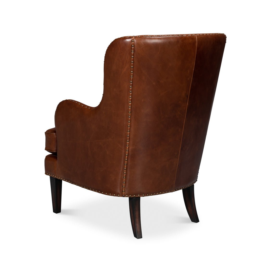 Brown leather wing chair, rear angle view.