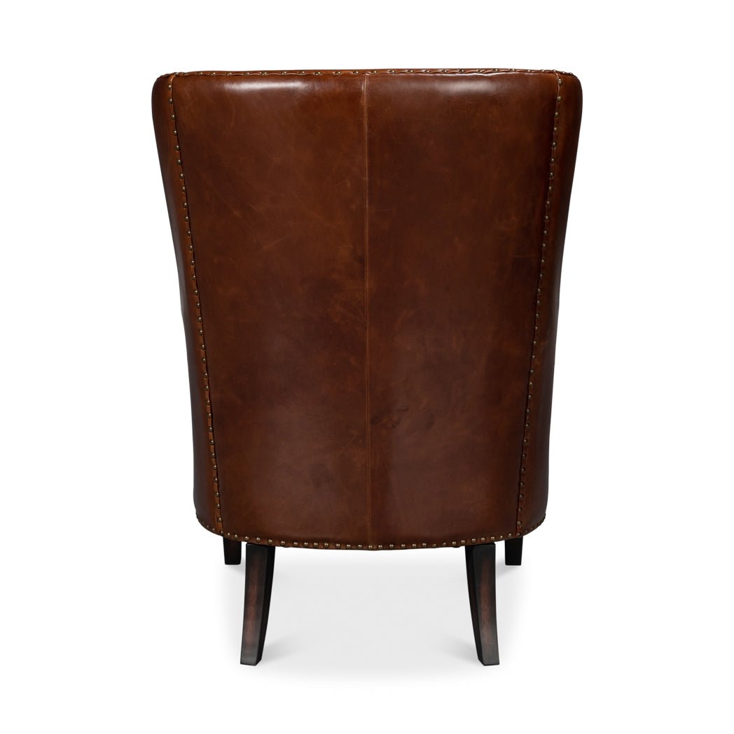 Brown leather wing chair, back view.
