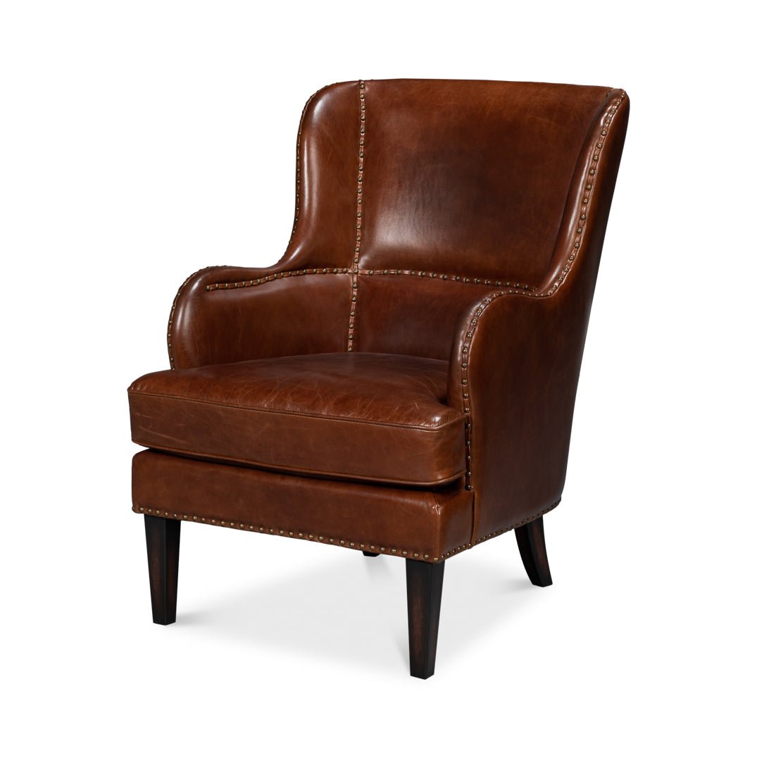 Brown leather wing chair, front angle view.