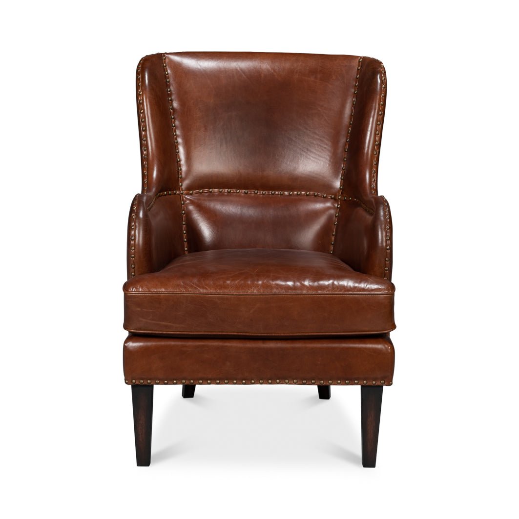 Brown leather wing chair, direct front view.