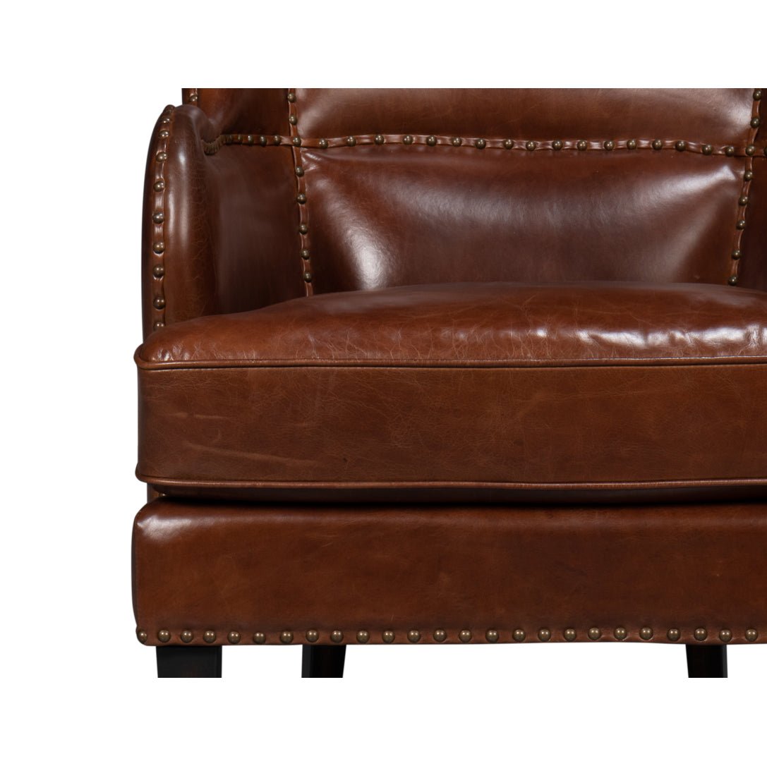 Brown leather wing chair, close-up seat detail.