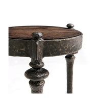 Detailed iron rim on round accent table surface.