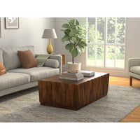 Coffee table in modern living room setting with decor.