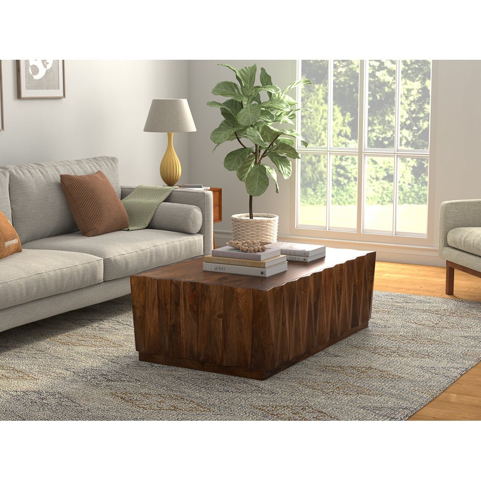 Coffee table in modern living room setting with decor.