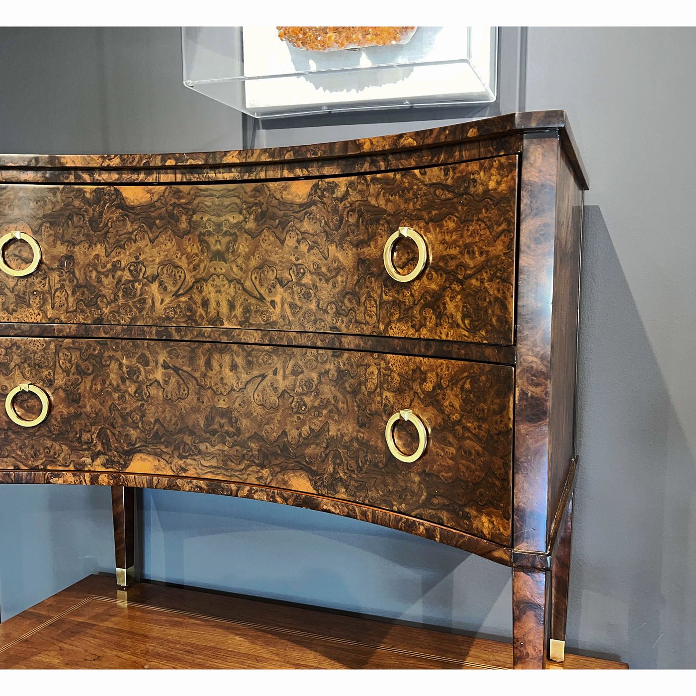 Close-up of drawer pull on burl walnut chest.