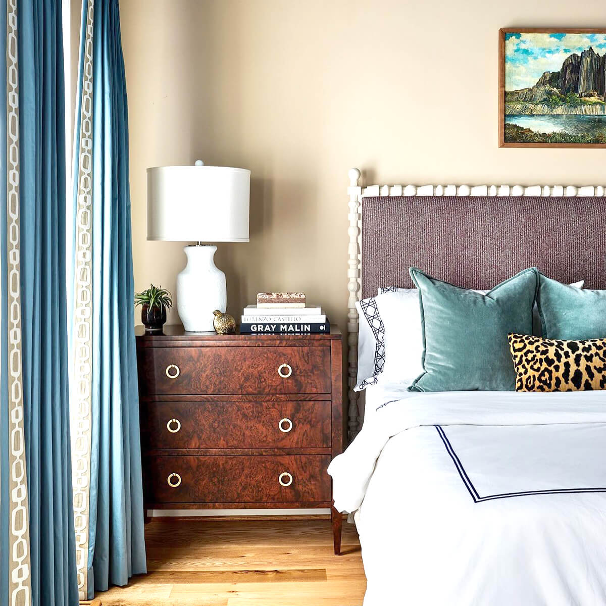 Burl walnut chest next to bed, styled interior.