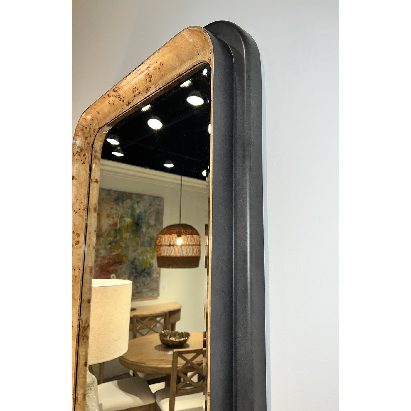 Side view of mirror with wood and black frame details.