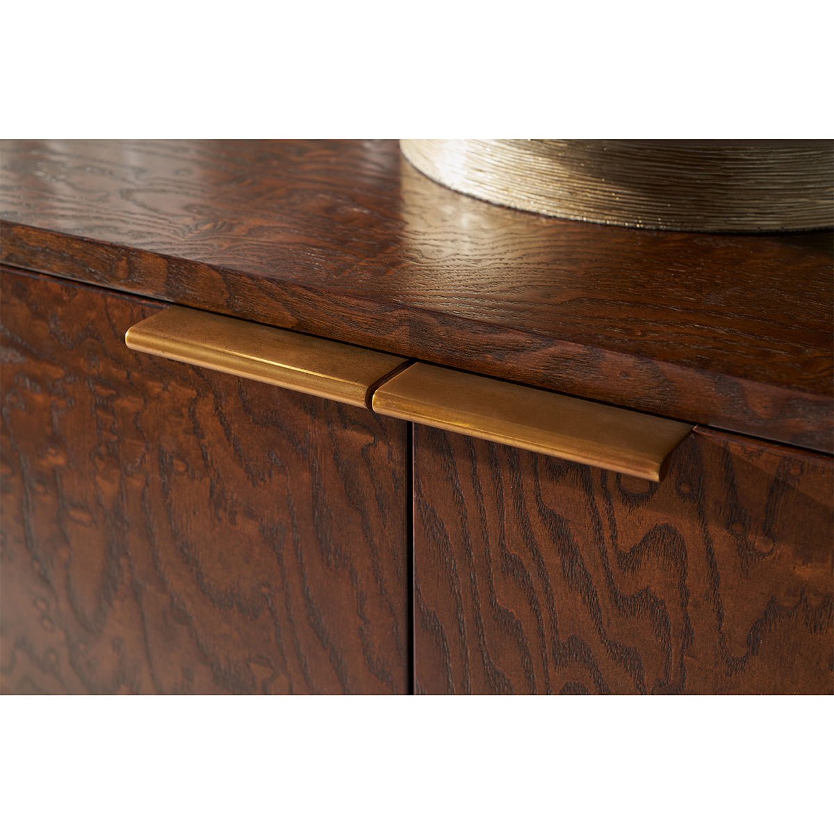 Close-up of handles on burl wood sideboard.