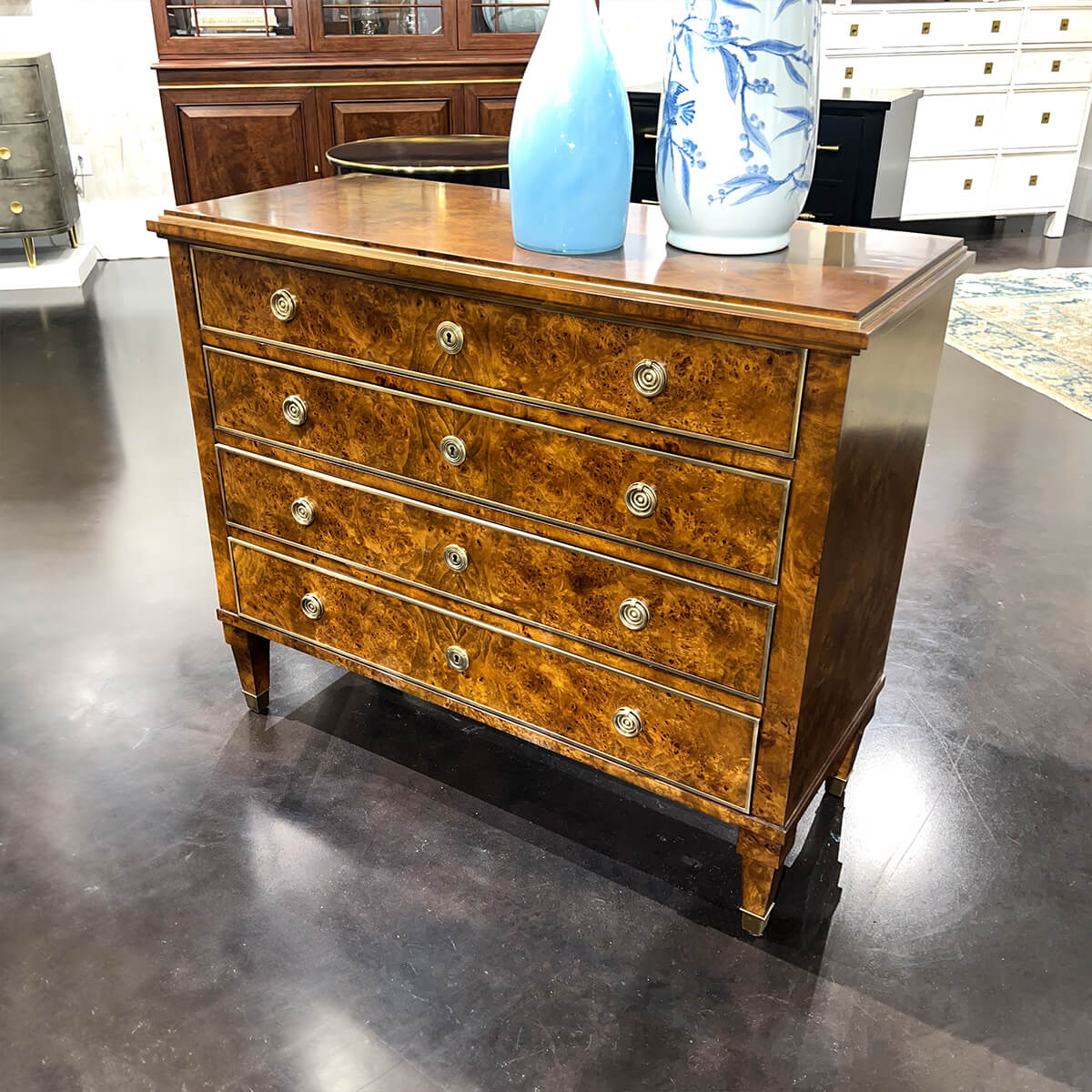 Burl wood chest angle view with vases.