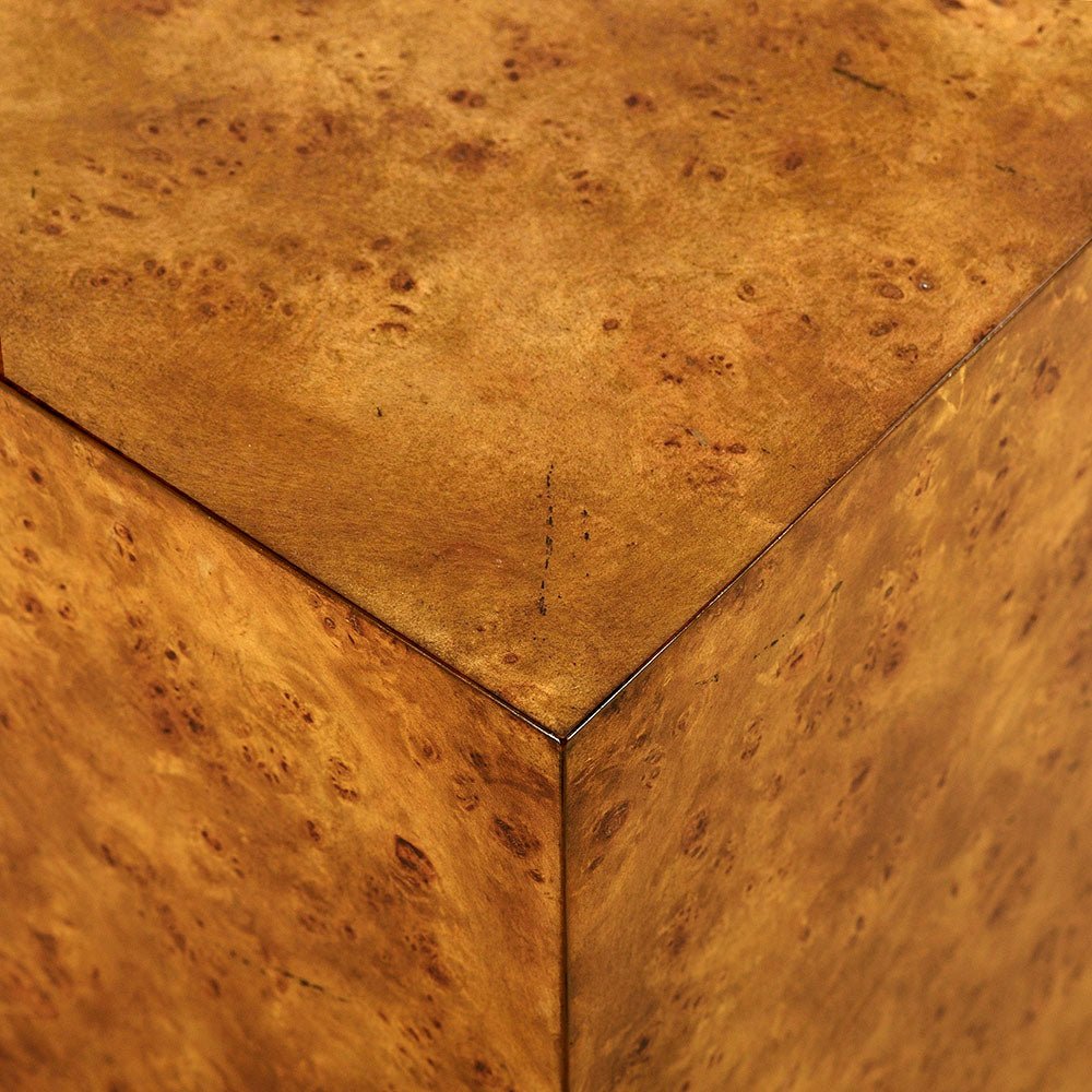 Close-up of burl wood texture on table corner.
