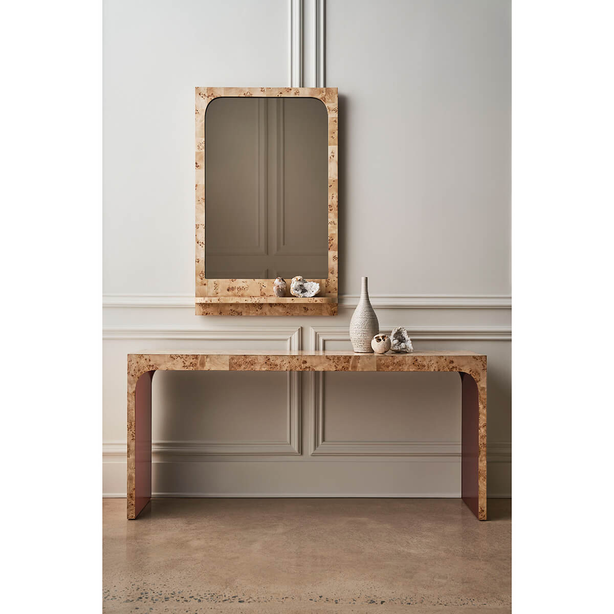 Burl wood mirror above console table, classic interior decor.