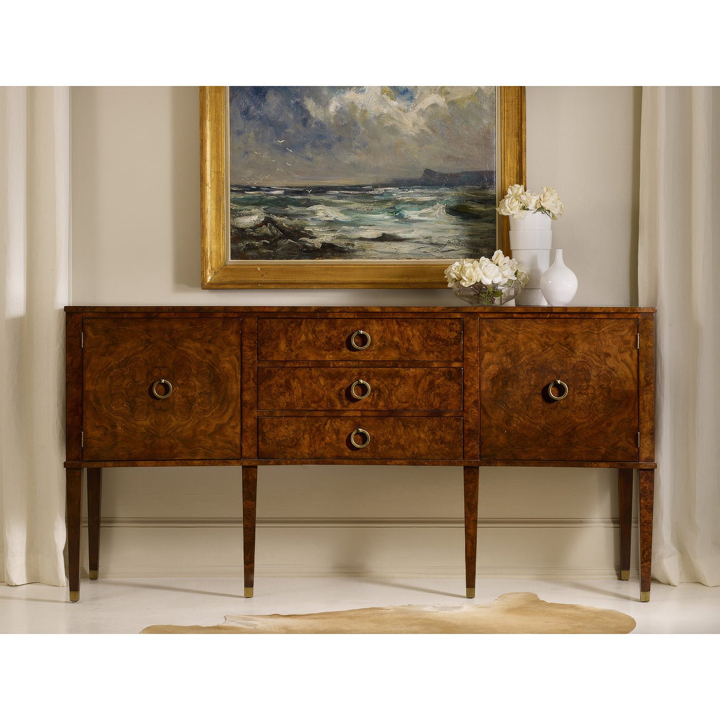 Burl wood sideboard in elegant room setting, painting above.