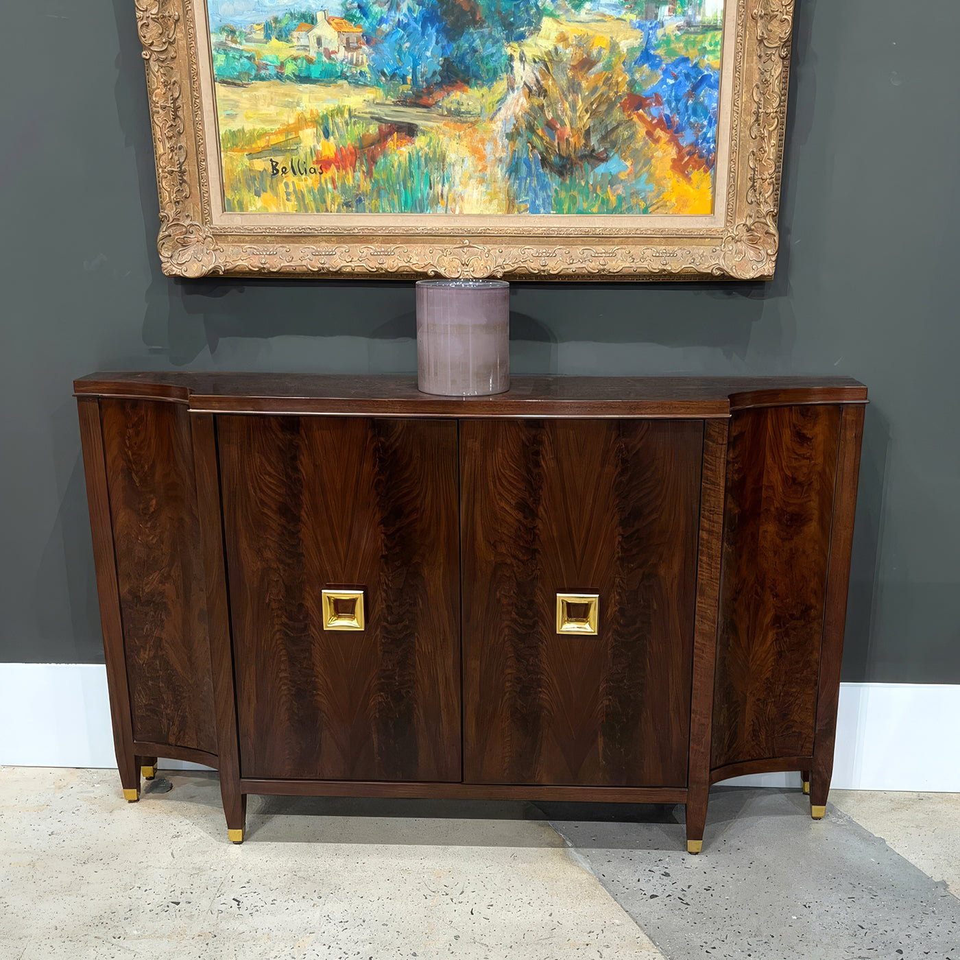 Sideboard under framed artwork, decorative display.