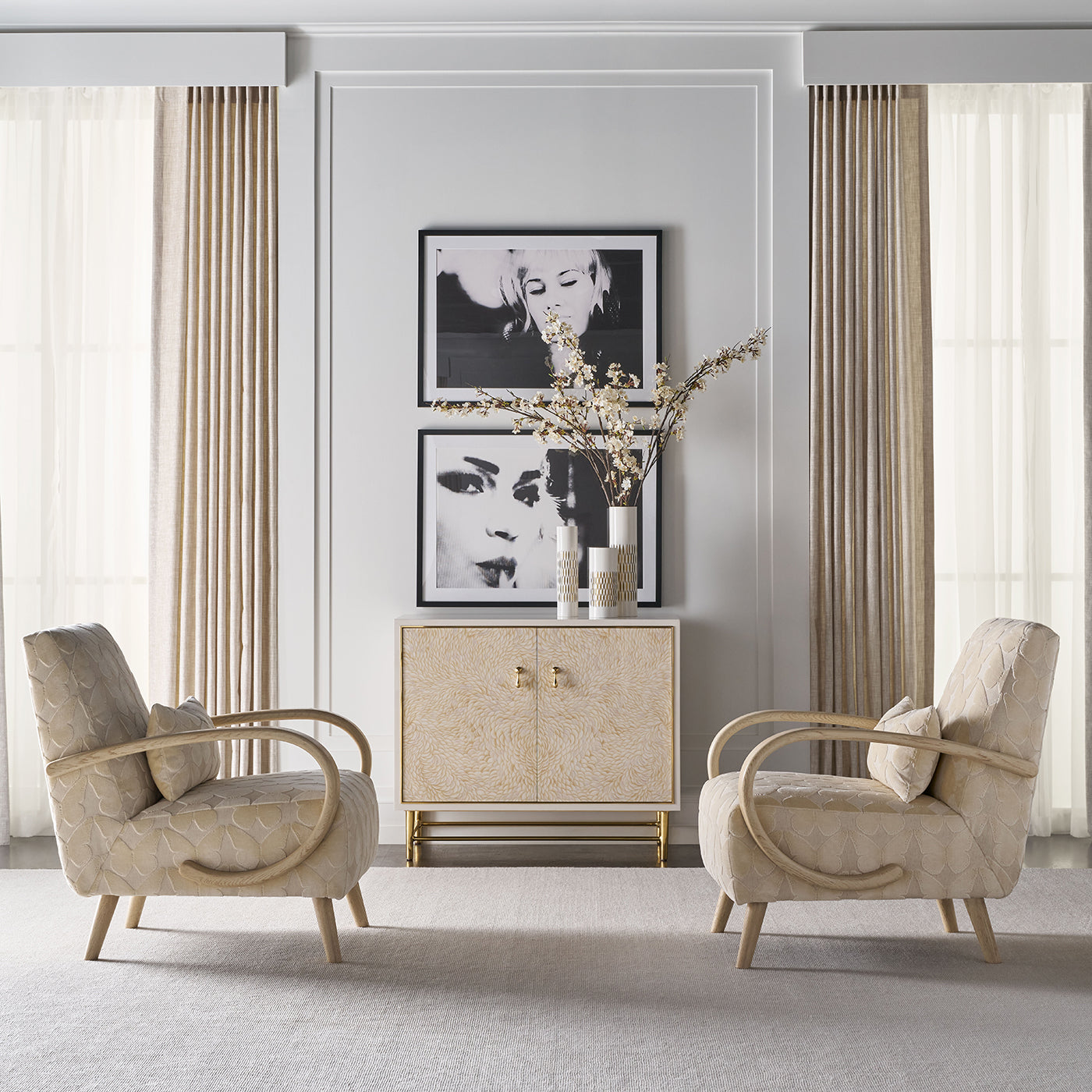 Living room with two chairs and cabinet against wall.