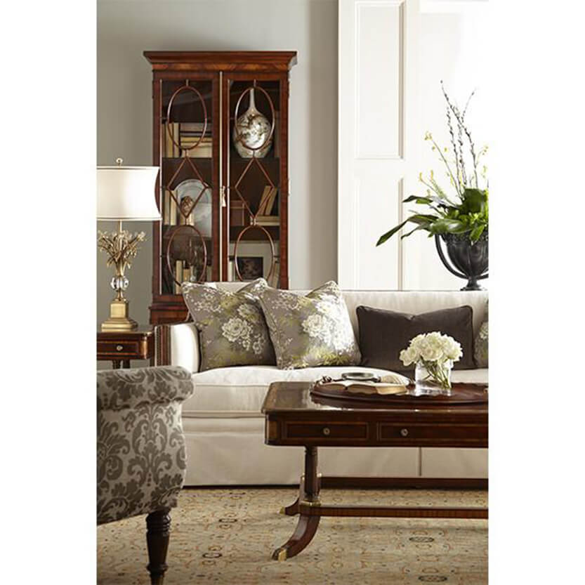 Callisto sofa in living room setting with floral pillows.